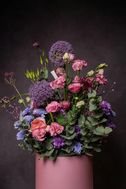 Pink roses and lilies in a white vase